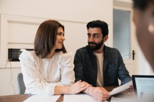 Man and woman at a realtors office after having a home inspection.