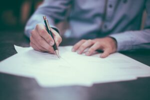 Picture of someone signing a document after having a home inspection